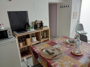 a kitchen with a table with a table cloth on it at le petit moulin in Montendre