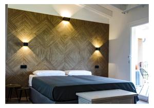 a bedroom with a bed with a wooden wall at La Mora Bianca in Assemini +21 photos