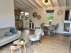 a living room with a couch and a table at Vakantiehuis Nynke in Grou