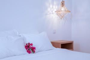 a bedroom with a bed with white sheets and a table at Mar-Ria 2 in Fuzeta +7 photos