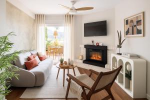 a living room with a couch and a fireplace at Beachside San Martin de Valdeiglecias in San Martín de Valdeiglesias