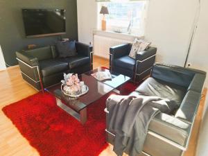 a living room with two chairs and a coffee table at Chalet an der Bode - Schicke 3 Zi Fewo mit Balkon in Braunlage