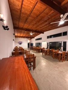 a large dining room with wooden tables and chairs at Las Lomas Suites & Spa in Chascomús