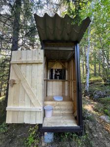 a wooden out house with a frisbee in it at idyllisk hytte ved vannet in Skien +2 photos