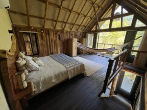 a bedroom with a bed and a hammock in it at Mar y Sierra in Minca