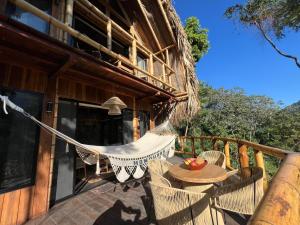a hammock on the deck of a house at Mar y Sierra in Minca