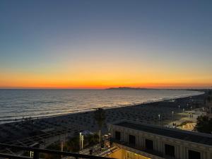 a view of the beach at sunset at SunKissed Apartament in Golem +2 photos
