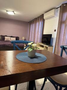 a dining room table with a vase of flowers on it at Villa Nikoleta in Sveti Vlas