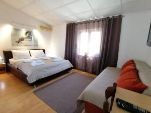 a bedroom with two beds and a window at Apartments Knežević in Ulcinj