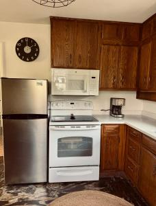 a kitchen with a refrigerator and a microwave at Chic Dunes Cottage with HOT TUB near Warren Dunes  +21 photos