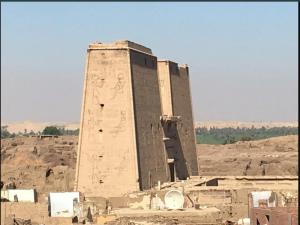 a building with paintings on it in the desert at El Massa in Idfu