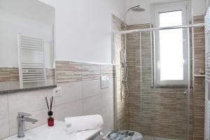 a bathroom with a sink and a shower at Bella Puglia Bed and Breakfast in Ruvo di Puglia