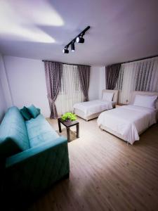 a living room with two beds and a couch at Cappadocia Beyaz Konak 1 in Gülşehir