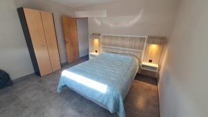 a bedroom with a bed with a blue blanket on it at 25deMayo in Veinticinco de Mayo