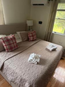 a bedroom with a bed with two towels on it at Cozy Modern 2BR Near Grays Beach in Kingston