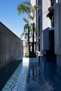 a pool of water with palm trees next to a building at Oplus11 in Toucheng