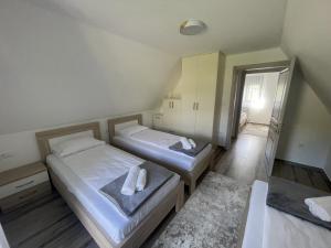 a bedroom with two beds and a mirror at BOK Holiday VILLAGE Kolasin in Kolašin