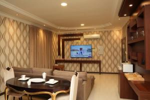 a living room with a couch and a table at ELGOUN Serviced apartments in Riyadh