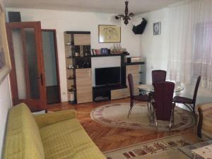 a living room with a couch and a table with chairs at Apartments Aleksic in Sutomore