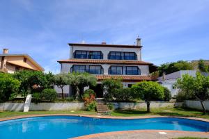 a house with a swimming pool in front of it at Casa Panorama in Zambrone