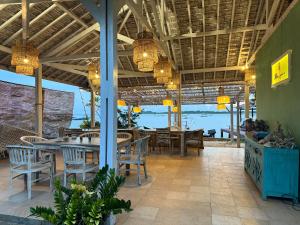 a restaurant with tables and chairs and a view of the ocean at Blue Laguna Inn in Karimunjawa