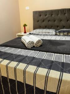 En eller flere senge i et værelse på Flat Outono Aconchegante 2