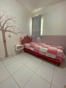 a bedroom with a bed with a tree painted on the wall at Casa Completa SJ - 6KM in Campina Grande