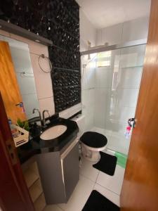 a bathroom with a sink and a toilet and a shower at Casa Completa SJ - 6KM in Campina Grande +2 photos