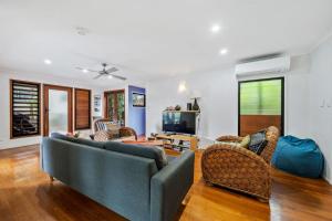 a living room with a couch and chairs at Billa Blue by Discover Stradbroke in Point Lookout