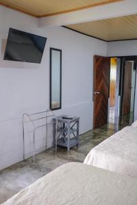 a bedroom with two beds and a table and a mirror at Blanca's House in Fortuna
