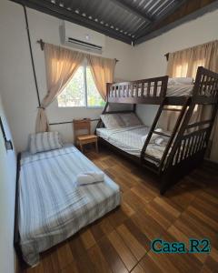 a bedroom with two bunk beds and a window at Casa Vacacional R2 in Santa Rosa +37 photos