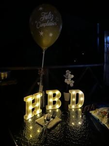 a balloon and a table with the word party at Chalet Guadalupe - Girardota in Estación San Andrés