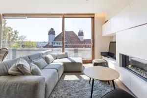 a living room with a couch and a large window at Shangri-La 0202 G in Sint-Idesbald