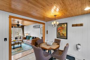 a dining room and living room with a table and chairs at Cozy Cottages Red Cottage Hot tubTown in Saugatuck