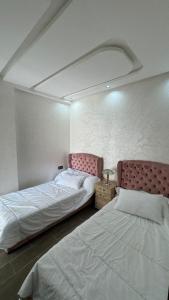 Ένα ή περισσότερα κρεβάτια σε δωμάτιο στο Appartement Mehdia