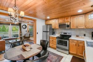 a kitchen with a wooden ceiling and a table and chairs at Cozy Cottages Brown Cottage Hot tubTown in Saugatuck +16 photos