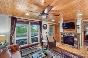 a living room with a couch and a ceiling fan at Cozy Cottages Brown Cottage Hot tubTown in Saugatuck