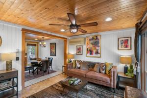 a living room with a couch and a ceiling fan at Cozy Cottages Brown Cottage Hot tubTown in Saugatuck