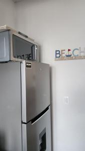 a refrigerator with a microwave on top of it at Casa 3 recamaras con alberca compartida Acapulco diamante in General Juan N Alvarez International Airport