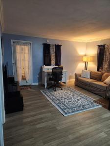 a living room with a couch and a desk at Countryside Comfort in Willseyville