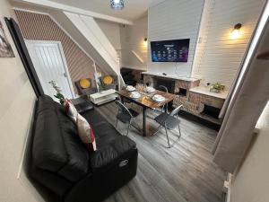 a living room with a couch and a table at Oldbury House - Bespoke for Contractors in Smethwick
