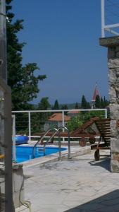 a swimming pool with a slide next to at Holiday Home Bobovisca in Ložišće