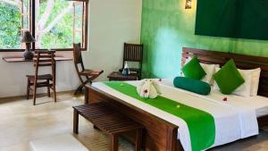 A bed or beds in a room at Garcinia Leaf