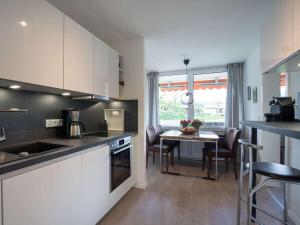 a kitchen and dining room with a table in it at 1-bedroom holiday apartment in Oberstdorf