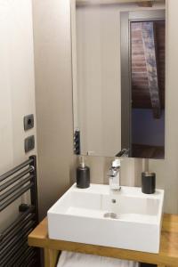 bagno con lavandino bianco e specchio di Guesthouse Mu ad Aosta