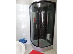 a shower in a bathroom with a red rug at 1-bedroom holiday apartment in Berchtesgaden