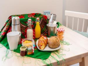 a table with a plate of croissants and other breakfast foods at Feel Porto Wine Essence II in Vila Nova de Gaia +32 photos