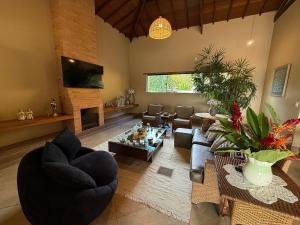 a living room with a couch and a fireplace at 7 QUARTOS, sendo 6 SUÍTES, PISCINA AQUECIDA borda infinita na REPRESA de DELFINÓPOLIS in Ibiraci