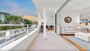 a living room with a balcony with a couch at Byron Centre Apartment with Pool in Byron Bay