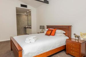 a bedroom with a bed with towels on it at Newcastle Penthouse - Sleeps 10 in Wickham